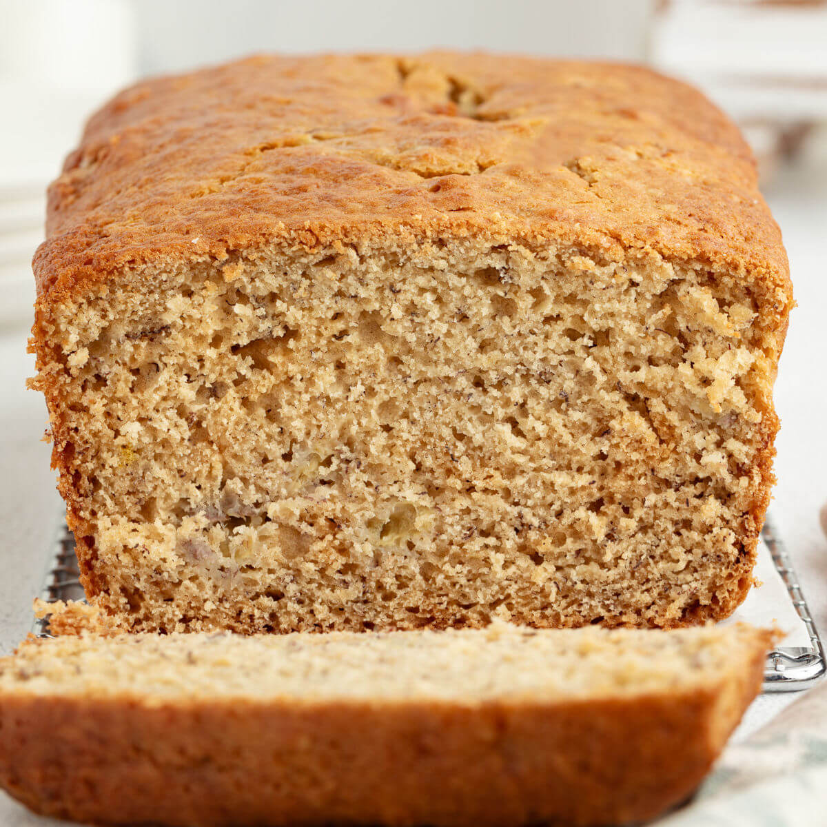 Loaf of sourdough banana bread with one slice cut out of it.