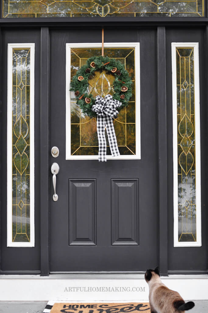 front door with buffalo check christmas wreath