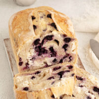 top down view of blueberry cream cheese sourdough bread loaf with two slices cut off