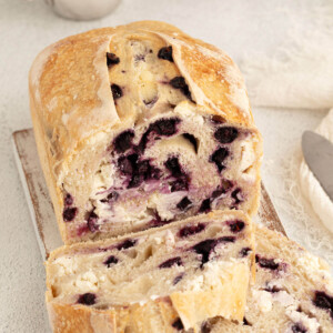 top down view of blueberry cream cheese sourdough bread loaf with two slices cut off