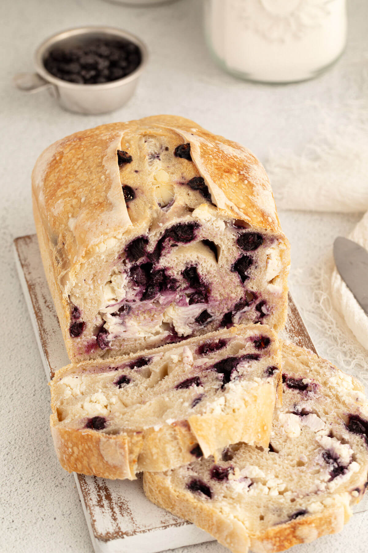 top down view of blueberry cream cheese sourdough bread loaf with two slices cut off