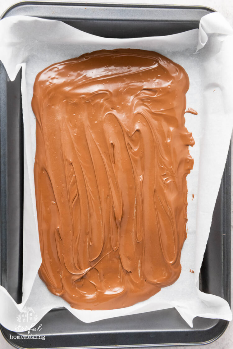 melted chocolate in a baking sheet with parchment paper