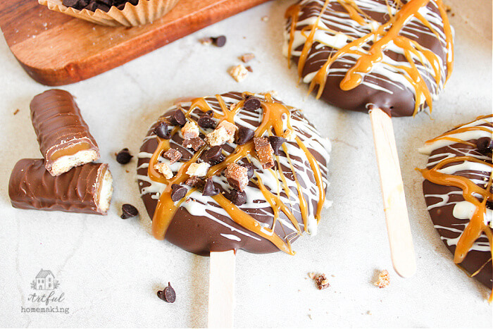 apples dipped in chocolate with candy bar next to it