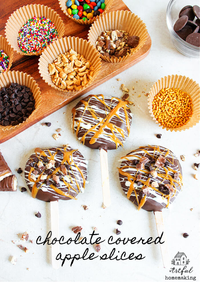 chocolate covered apple slices on a white countertop with toppings