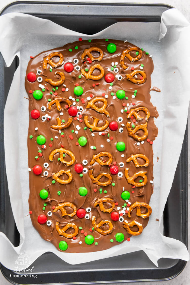 chocolate reindeer bark on parchment paper before cutting