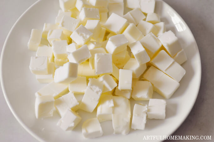 butter cut into cubes on a white plate