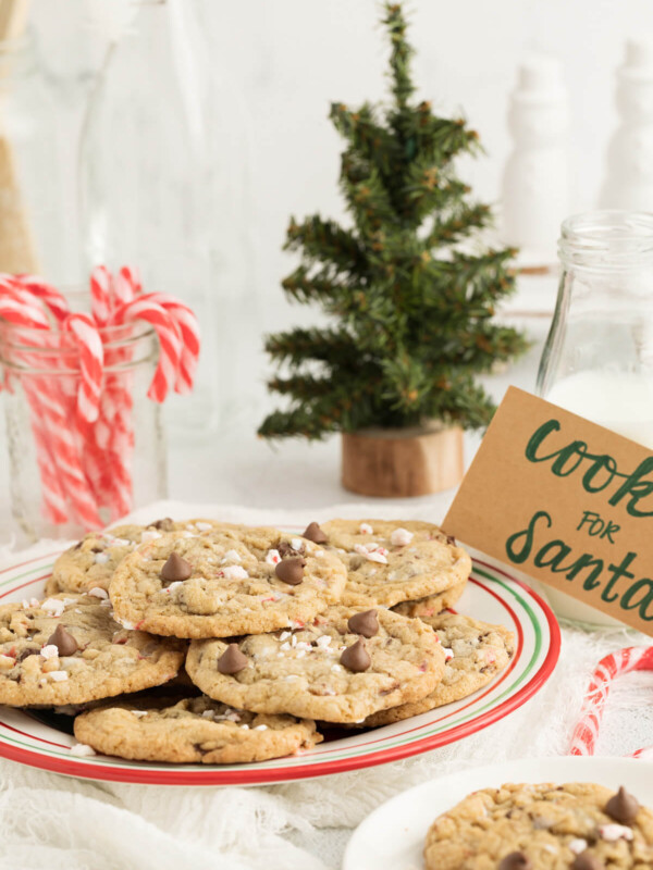 chocolate chip peppermint cookies next to peppermint sticks and a christmas tree