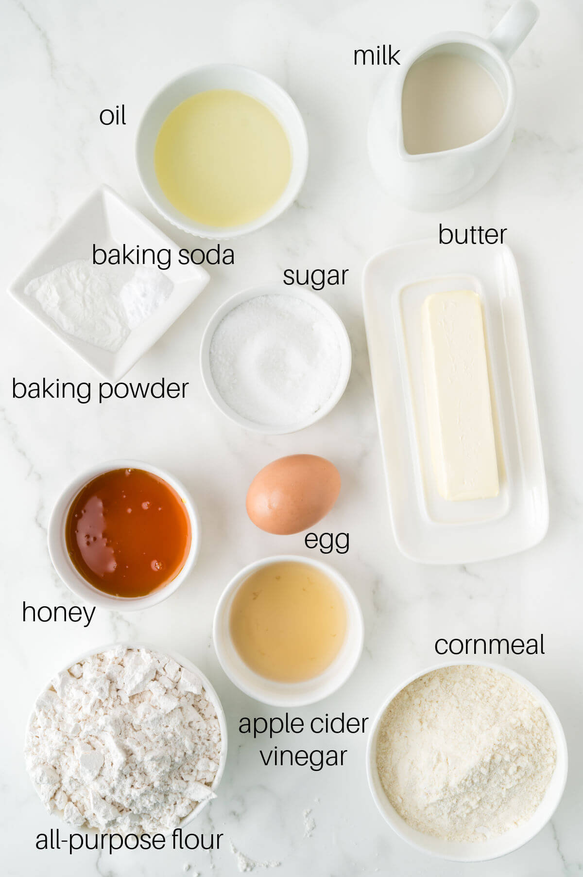 top down view of ingredients in small bowls on a white countertop
