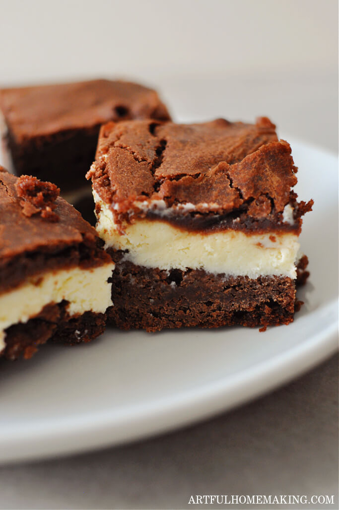 chocolate cream cheese brownies on a white plate