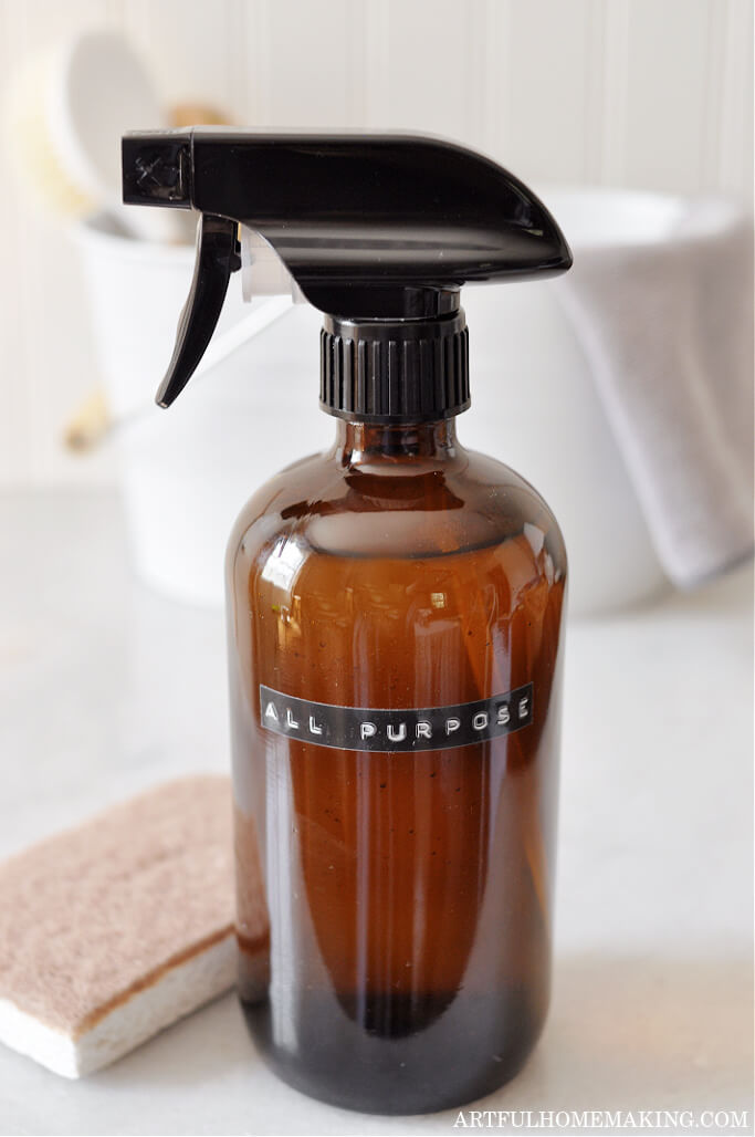 amber bottle with all purpose label and natural cleaning supplies