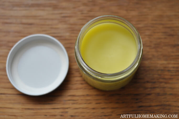 homemade comfrey salve in a jar on a wood table