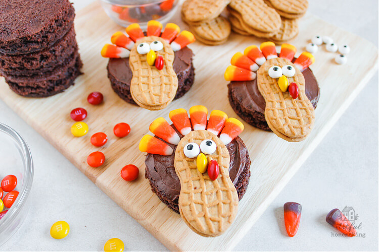 3 turkey brownies on a wooden cutting board