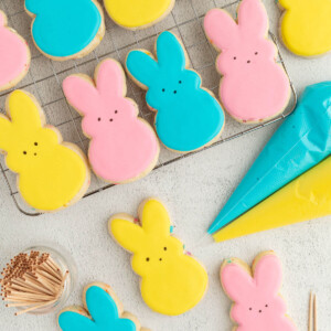 top down view of pastel tinted Easter sugar cookies shaped like rabbits