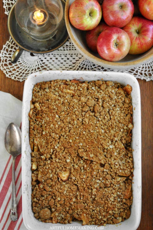 homemade Apple Crisp in a baking dish with fresh apples
