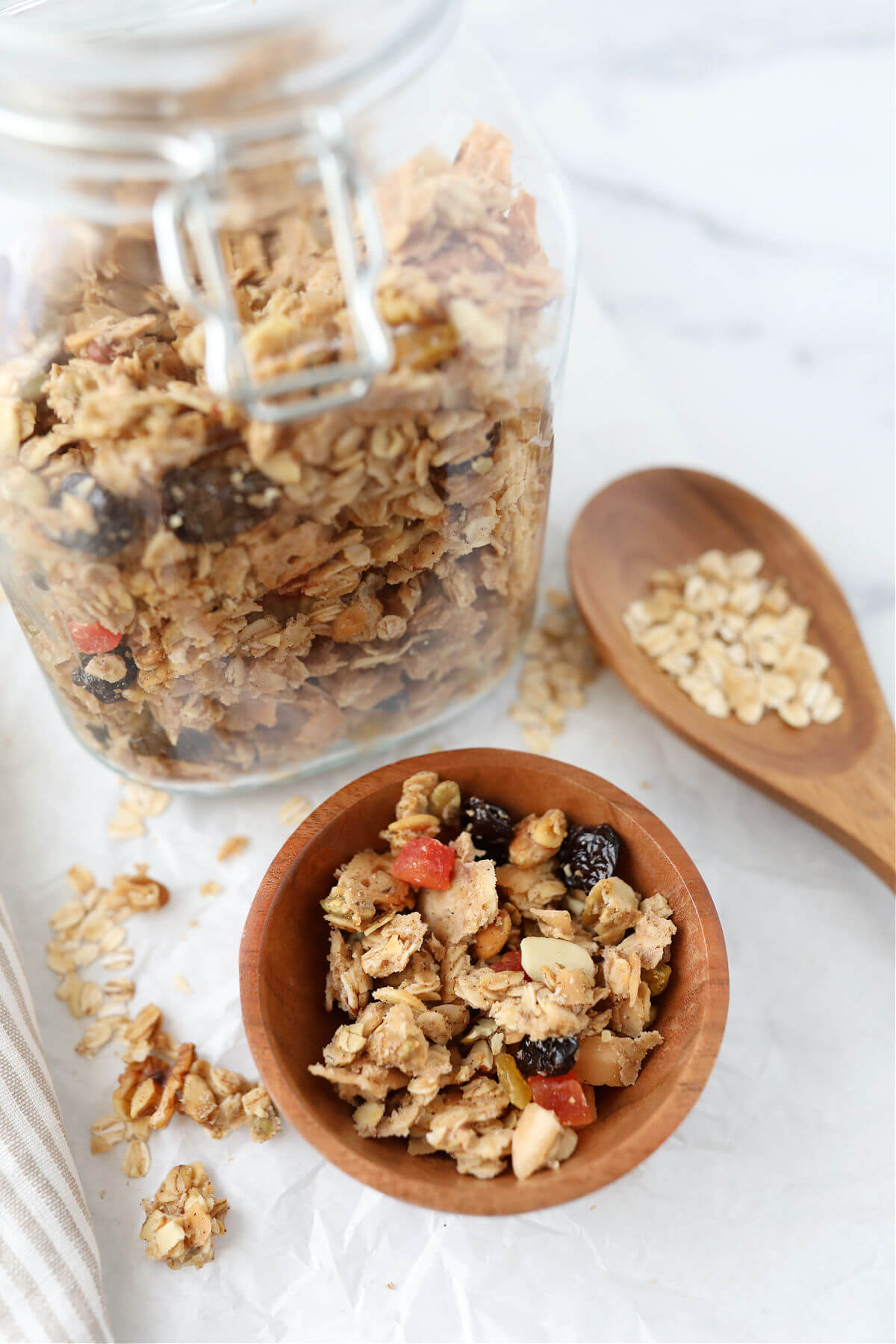 Sourdough granola in a bowl next to a glass mason jar full of granola.