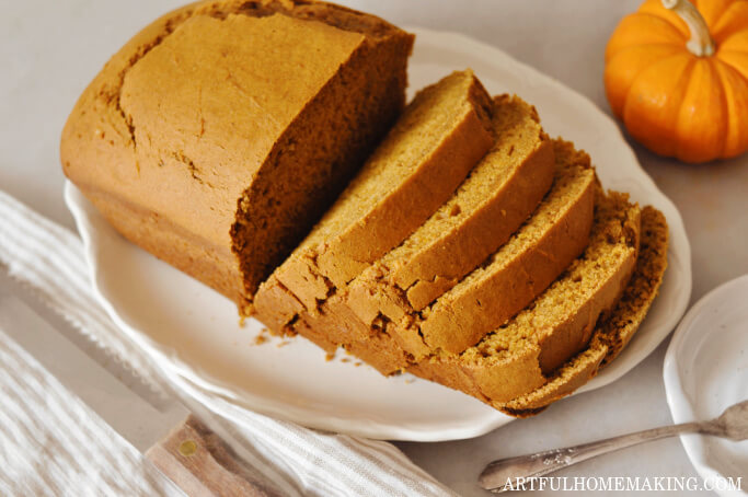 sourdough pumpkin bread cut into slices on a platter.