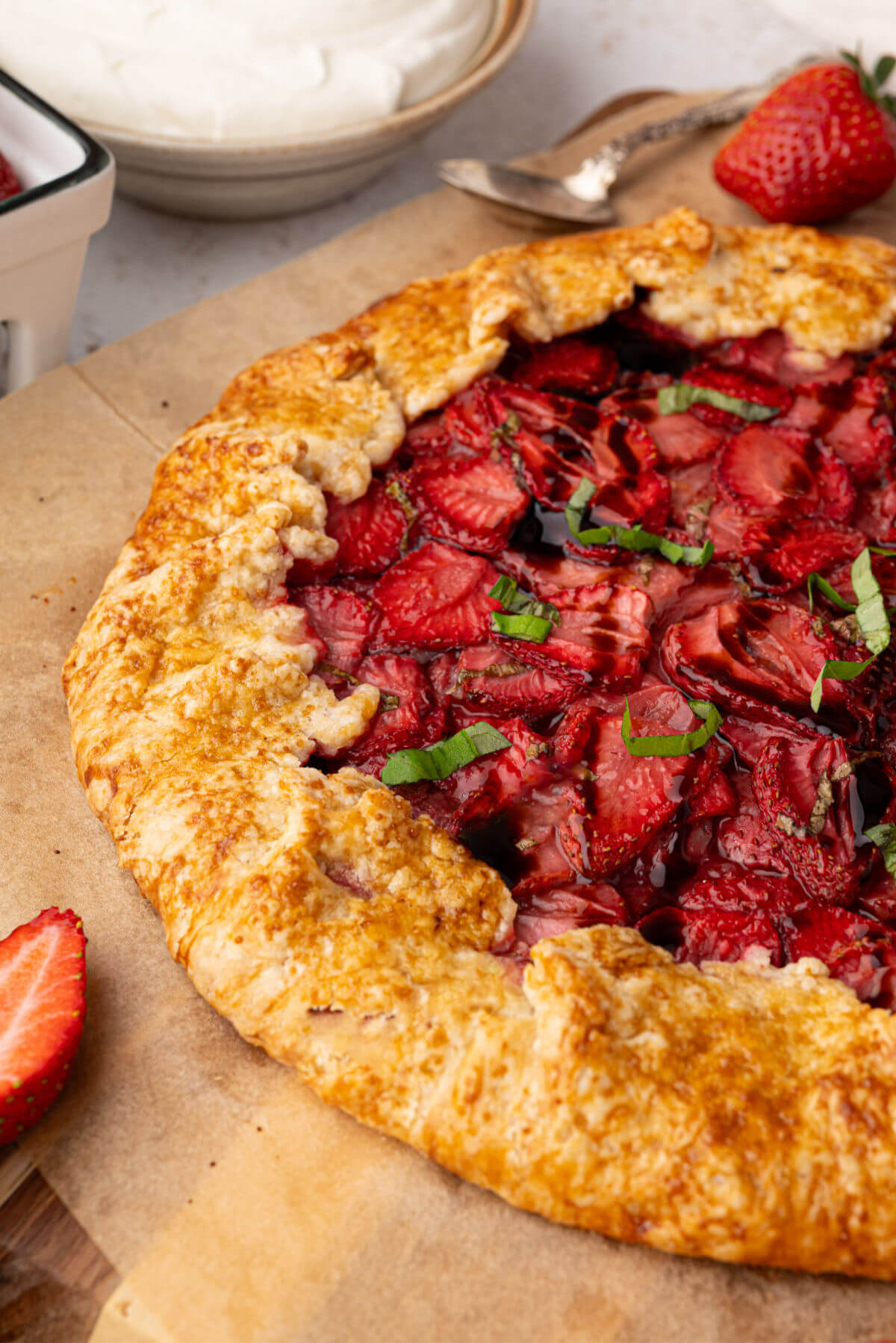 sourdough galette with strawberry filling on parchment paper after baking.