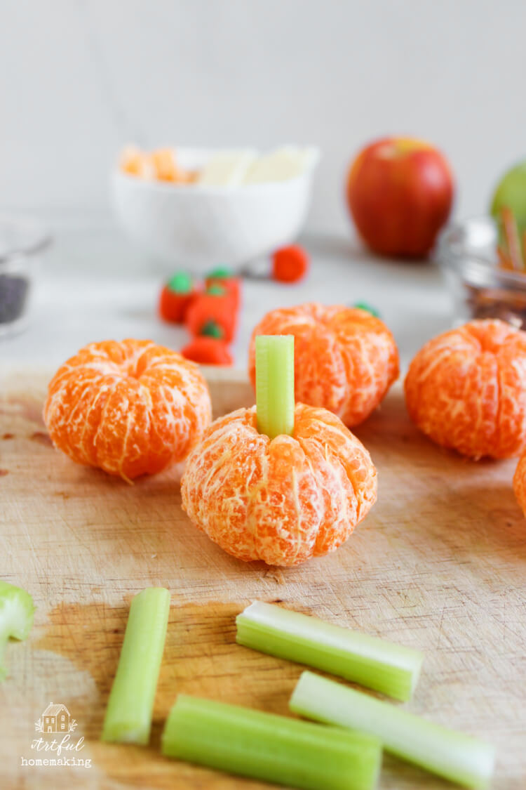 mini pumpkins made of mandarin oranges and celery
