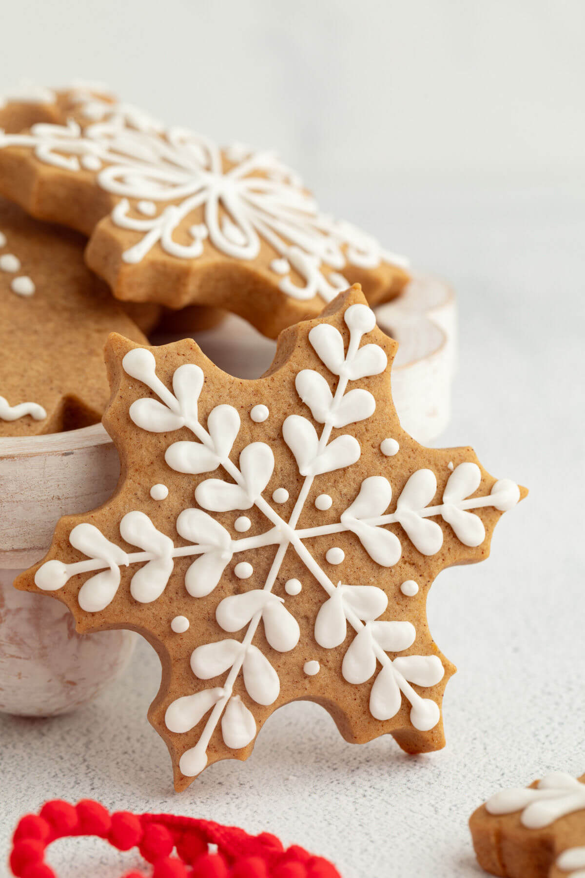 Sourdough gingerbread cookies with royal icing in a bowl.