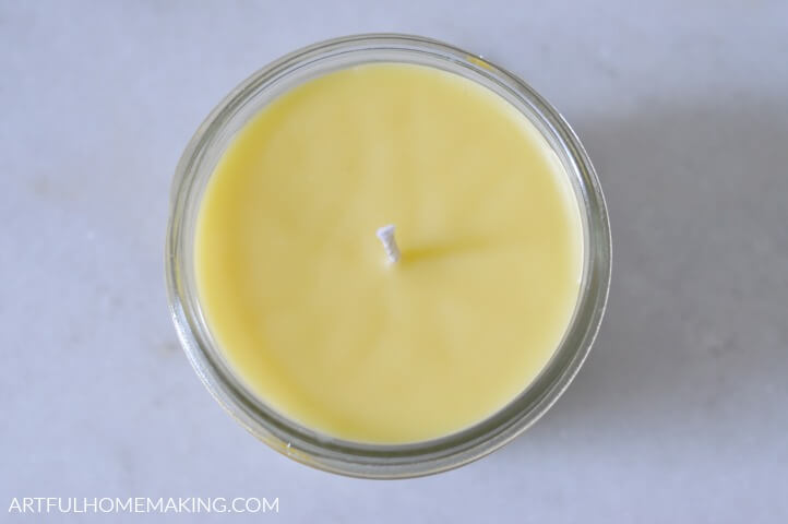 a top-down view of a poured beeswax candle in a jar