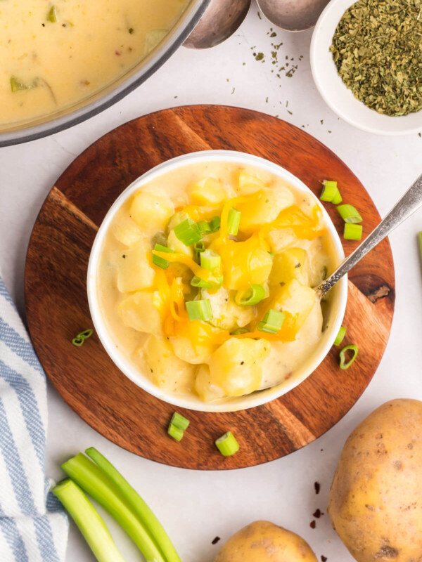 top down view of cheesy potato soup in a white bowl