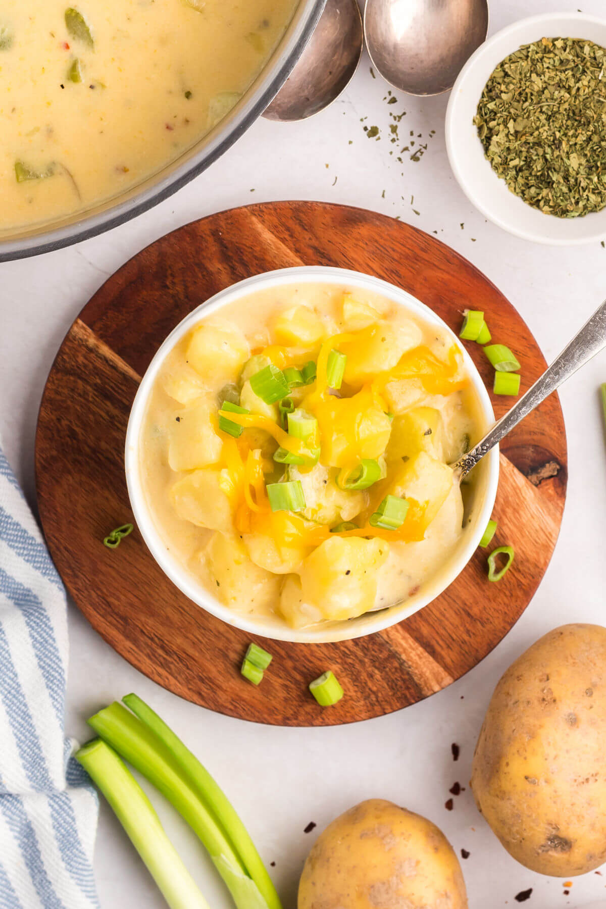 top down view of cheesy potato soup in a white bowl