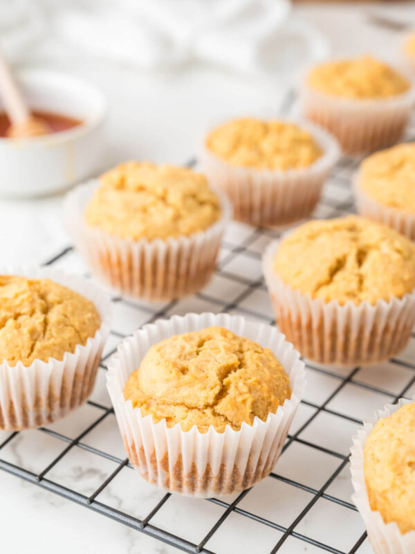 side view of cornbread muffins on a wire cooling rack