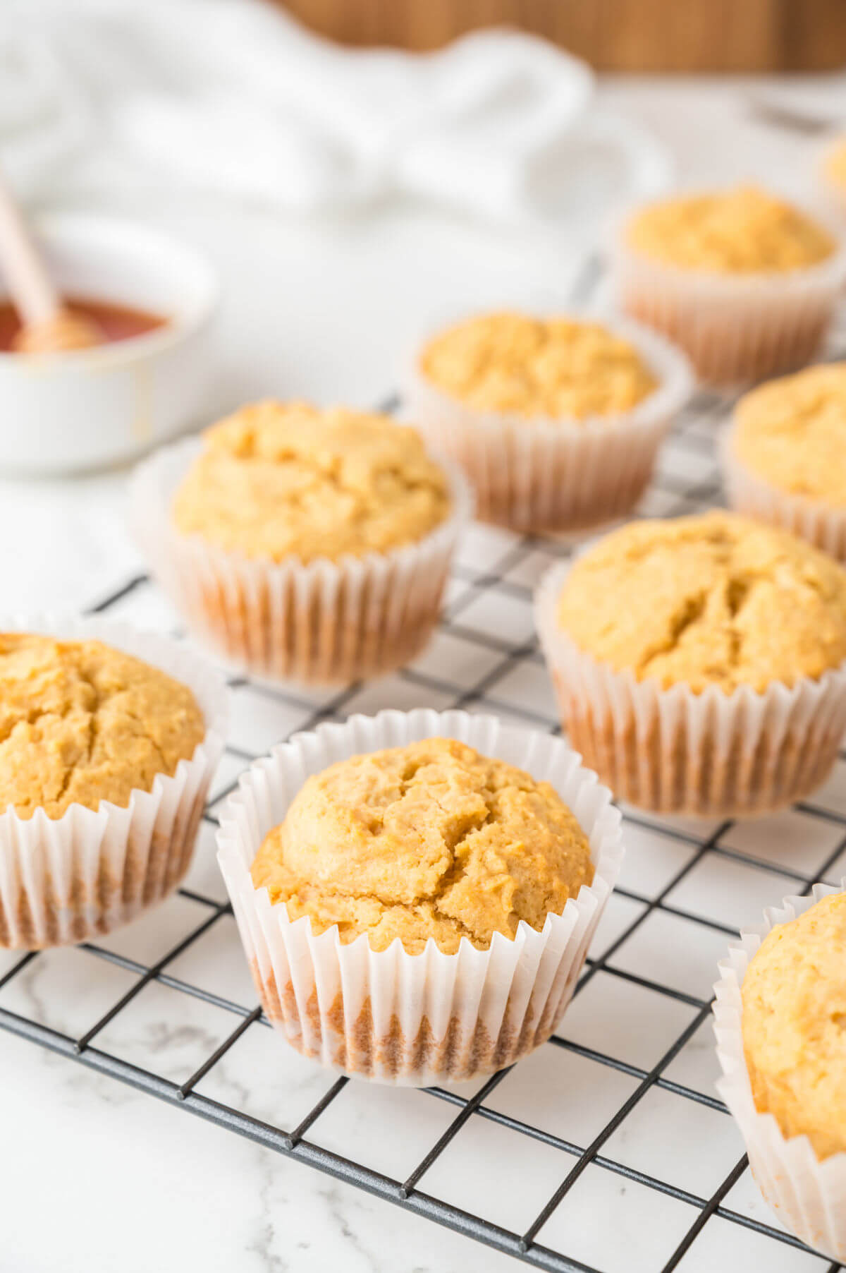 side view of cornbread muffins on a wire cooling rack