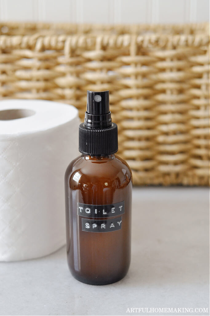 hoemade diy toilet spray with roll of toilet paper and basket