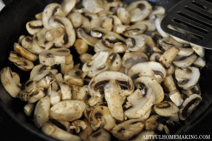 sliced mushrooms in a cast iron skillet