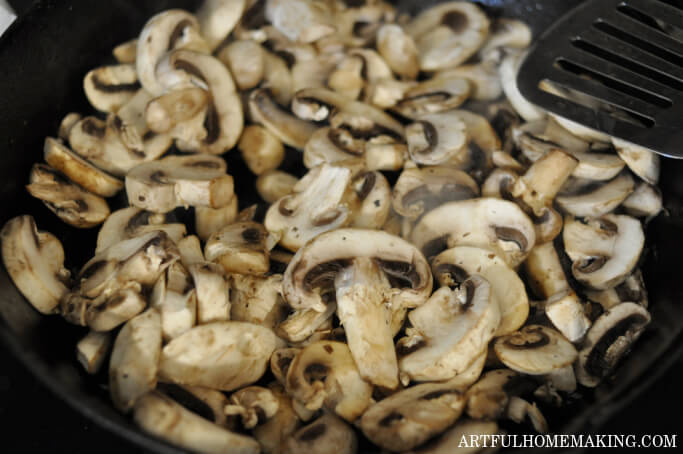 sliced mushrooms in a cast iron skillet