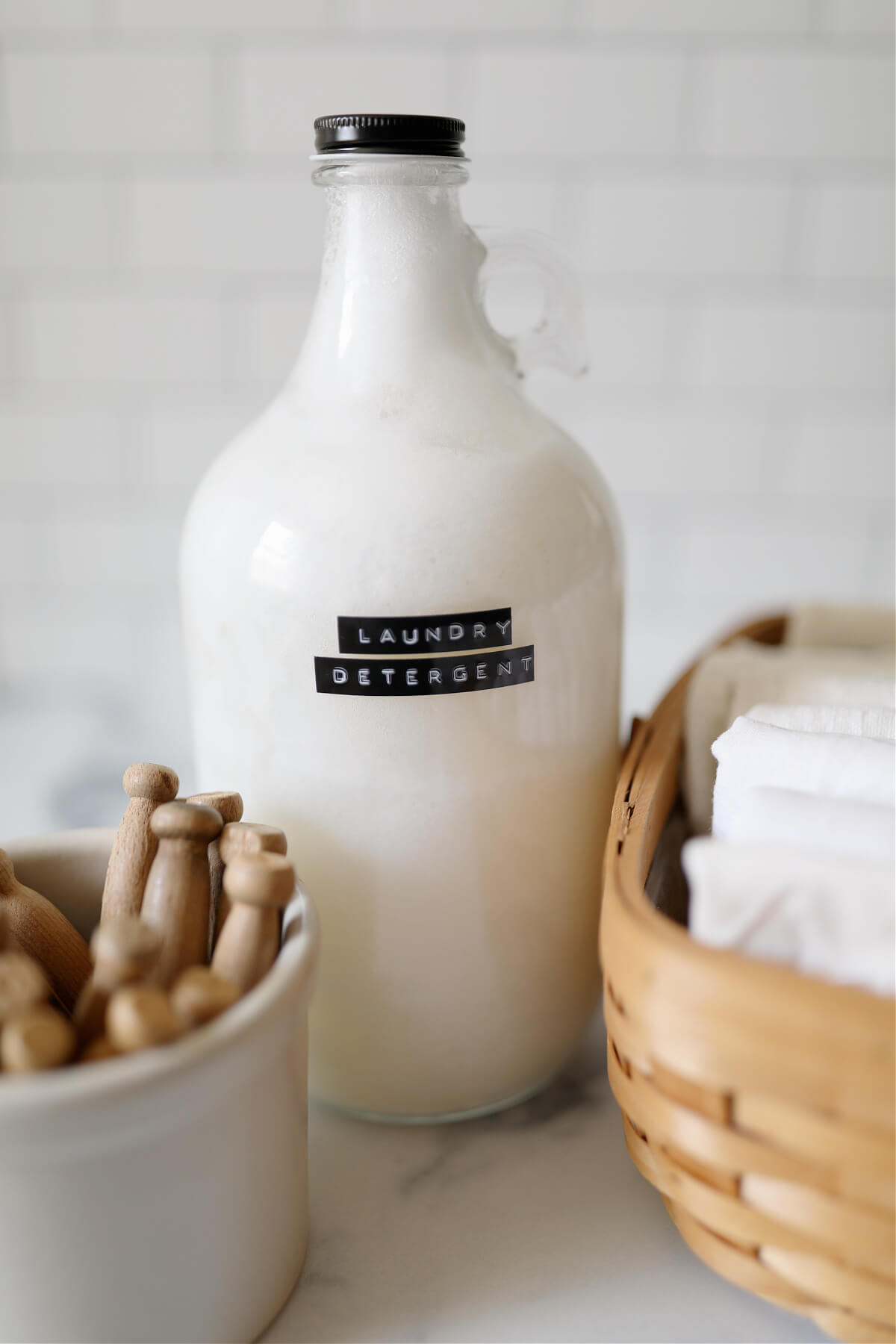 Homemade liquid laundry detergent in a labeled half gallon jar.