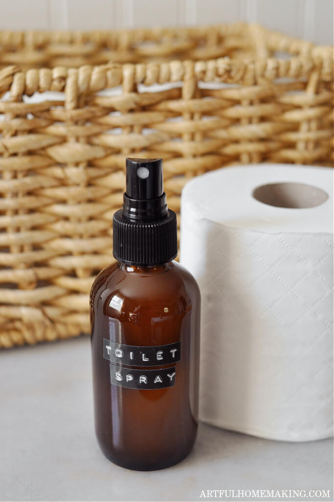 homemade natural diy toilet spray with basket and a roll of toilet paper