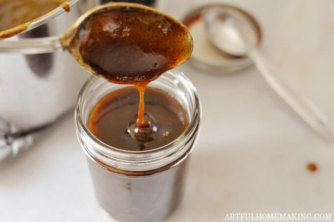 syrup mixture dripping from spoon into a glass jar