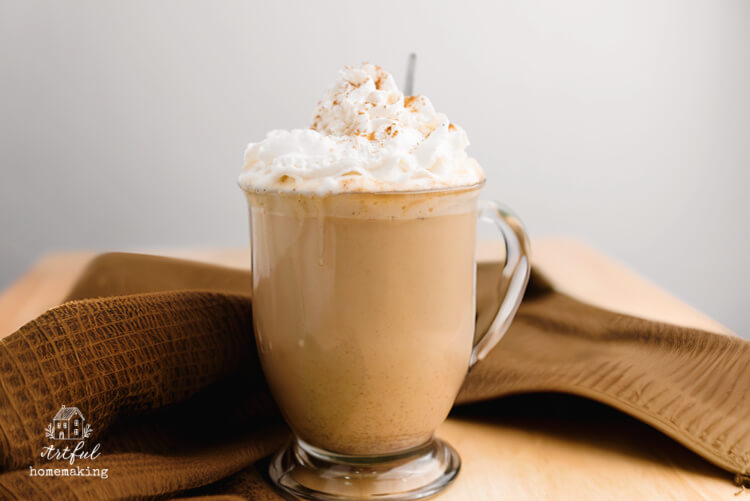 pumpkin spice latte coffee in a mug on a wood table