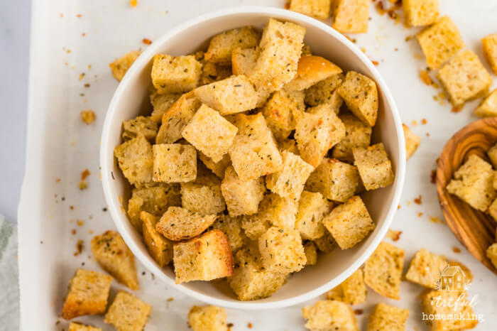 sourdough croutons in a bowl sitting on a sheet pan
