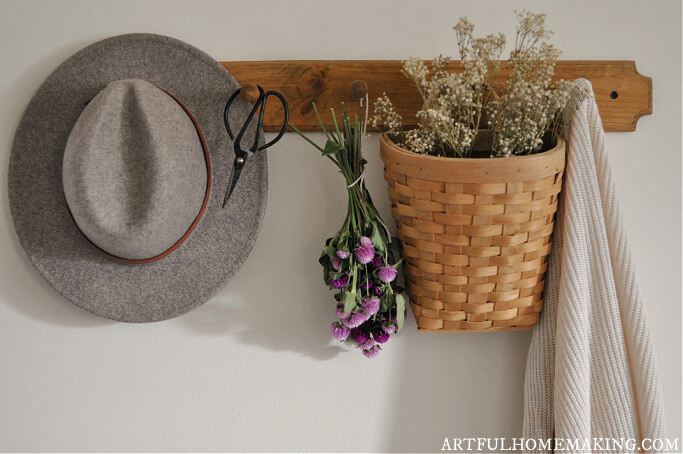 wooden peg shelf with hat and flowers