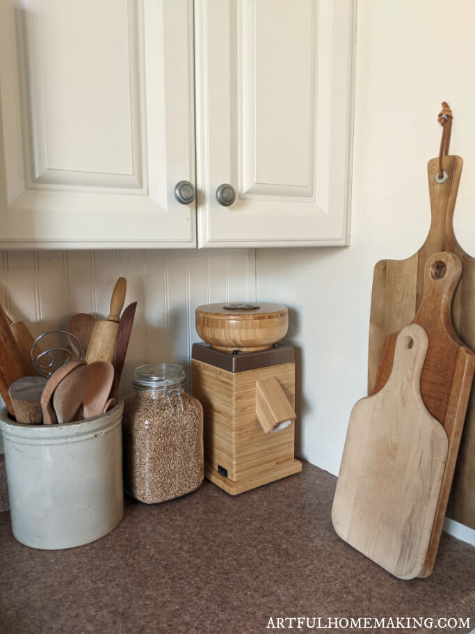 grain mill on kitchen counter with whole wheat in cannister