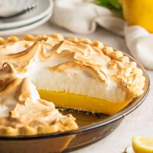 Lemon meringue pie in a glass pie dish.