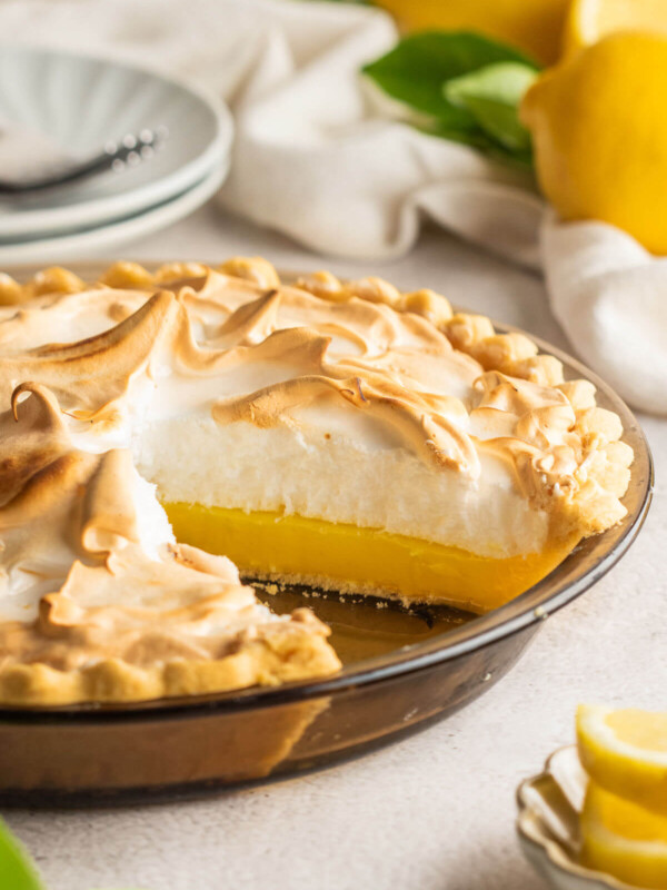 Lemon meringue pie in a glass pie dish.