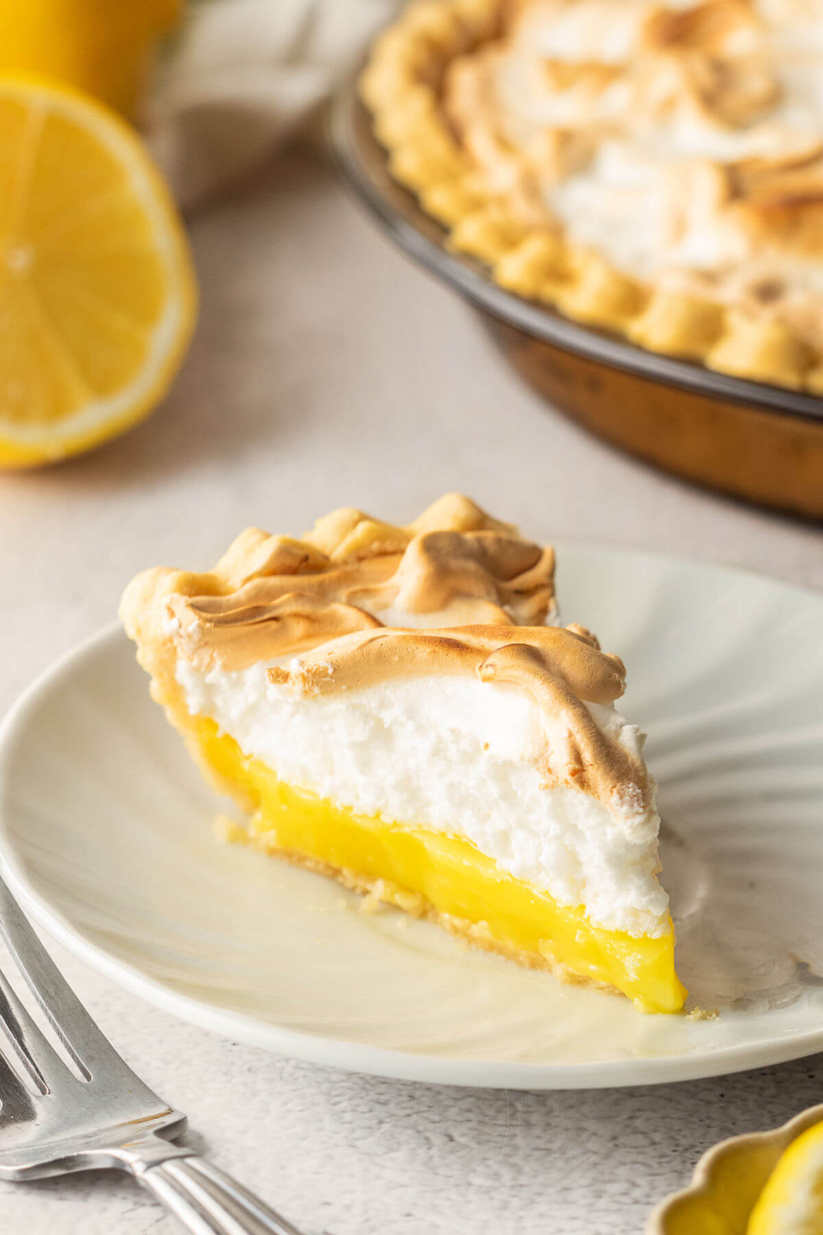 A slice of lemon meringue pie on a plate.