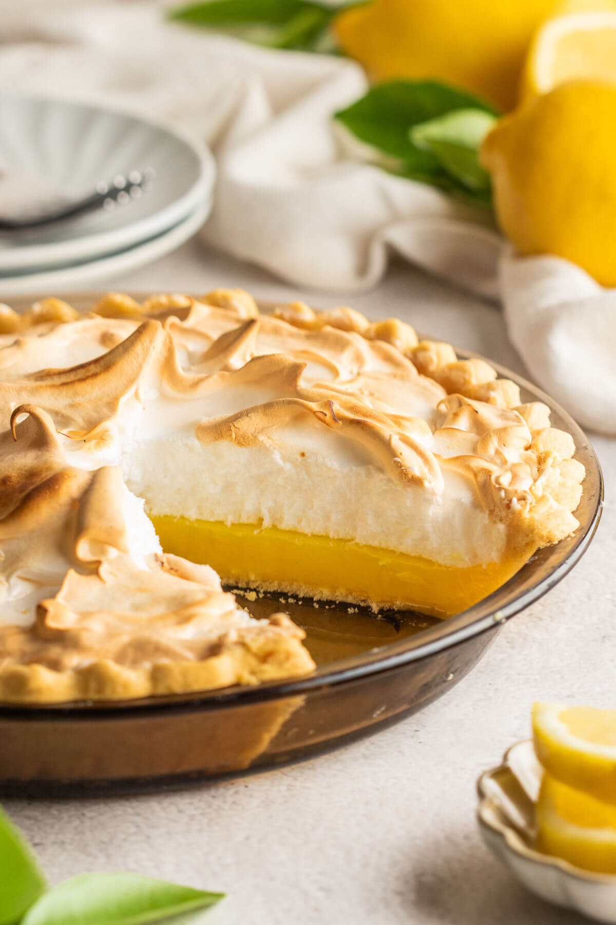 Lemon meringue pie in a glass pie dish.