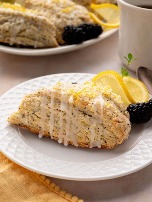 Sourdough lemon poppy seed scones on white plates.