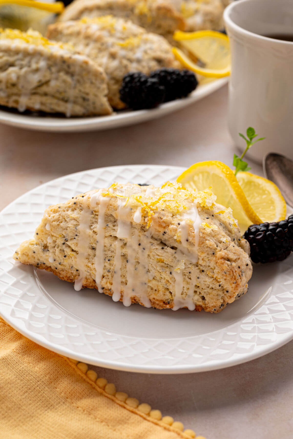 Sourdough lemon poppy seed scones on white plates.
