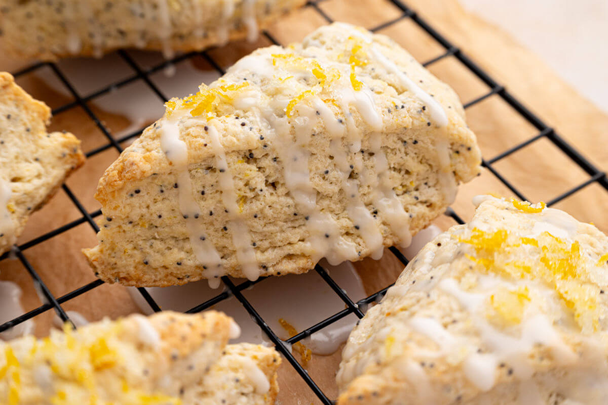 Sourdough lemon poppy seed scones on a cooling rack.