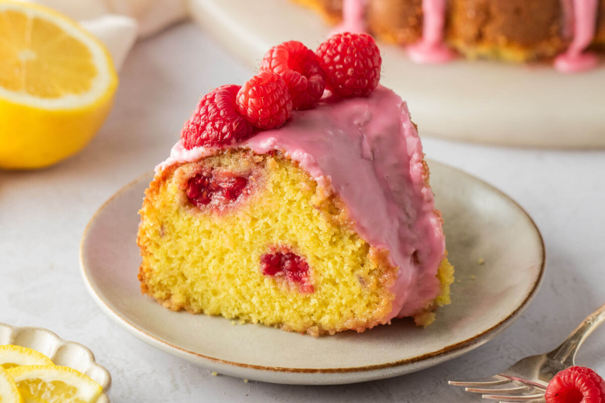 Slice of lemon raspberry bundt cake on a plate for serving.