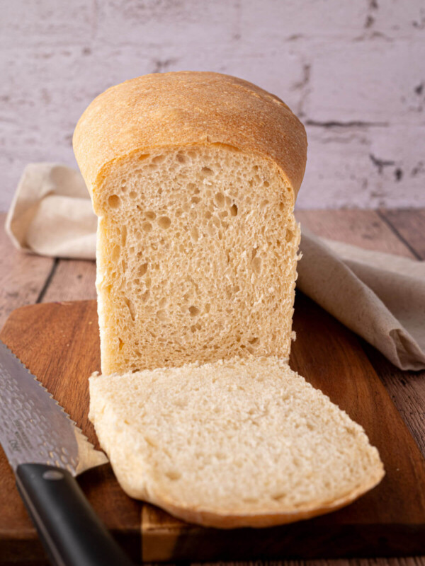 Easy sourdough sandwich bread loaf on a wooden cutting board.