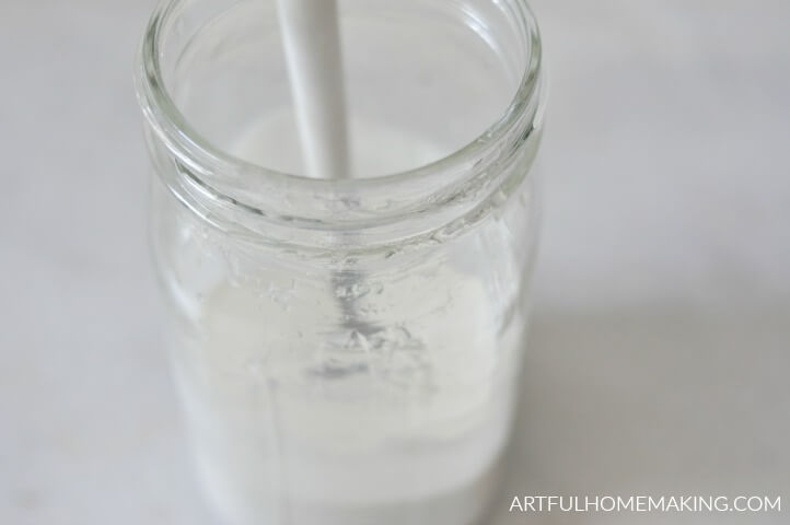 stirring ingredients in glass jar