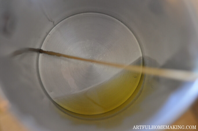 double boiler filled with melted beeswax, coconut oil, and cocoa butter