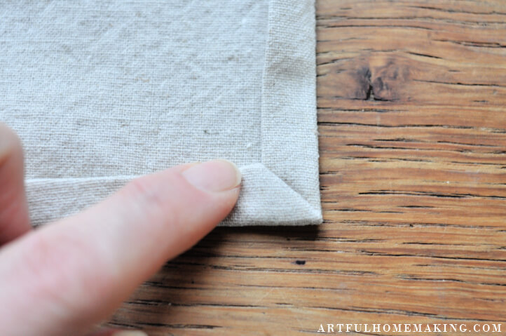 https://www.artfulhomemaking.com/wp-content/uploads/making-mitered-corner-on-cloth-napkin.jpg